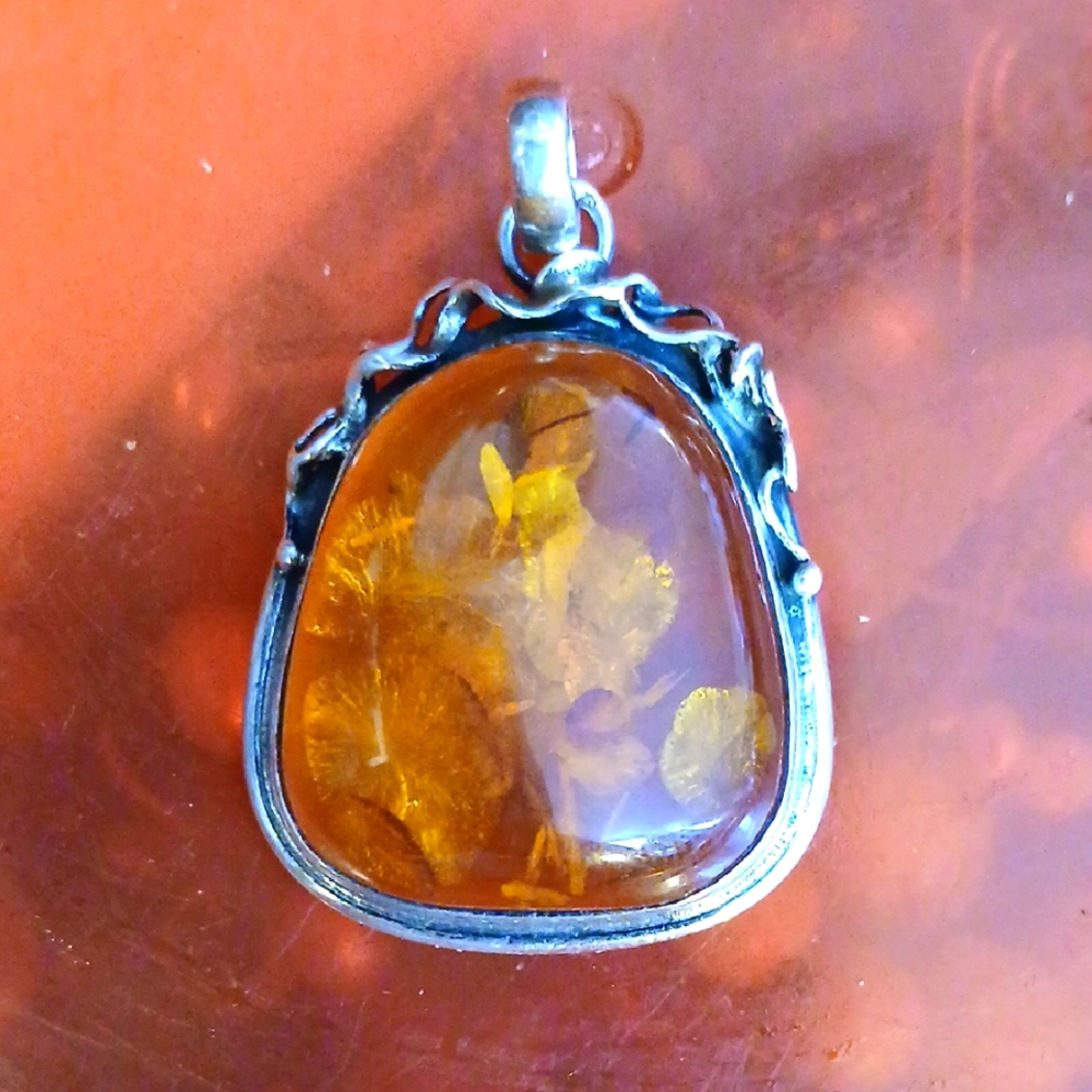 Elegant Amber Pendant with Sterling Silver Detailing
